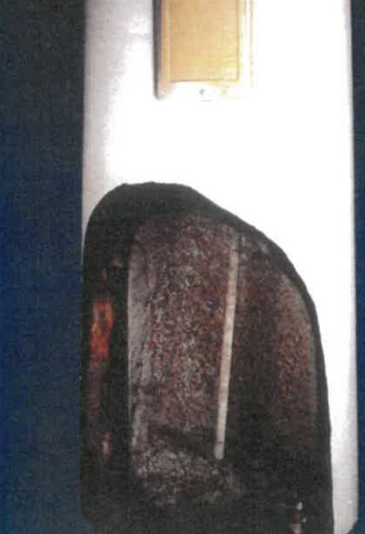 Water heater opened to show scale and sediment inside the tank