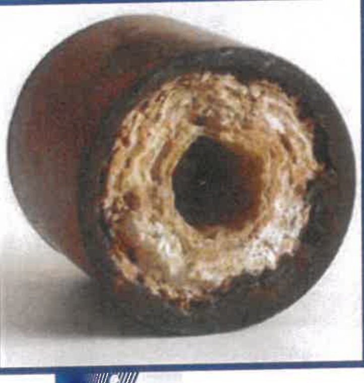 Cross-section of a water pipe with the opening closed down by rings of mineral scale